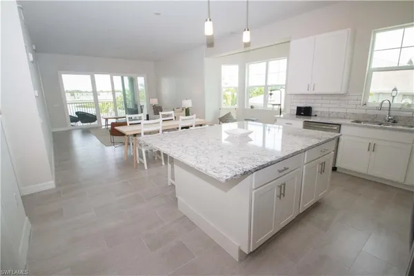 a kitchen with sink stove and cabinets