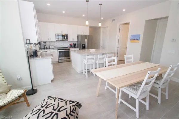 a kitchen with a sink a stove a refrigerator and cabinets