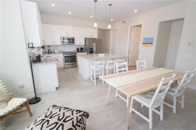 a kitchen with a sink a stove a refrigerator and cabinets