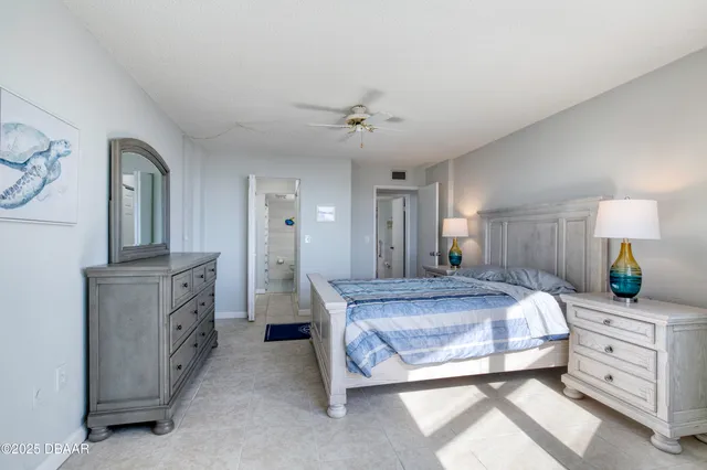 a bathroom with a granite countertop sink a toilet and a mirror