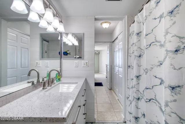 a bedroom with 2 bed and a window