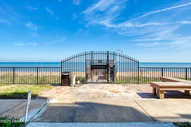 a living room with furniture a flat screen tv and kitchen view