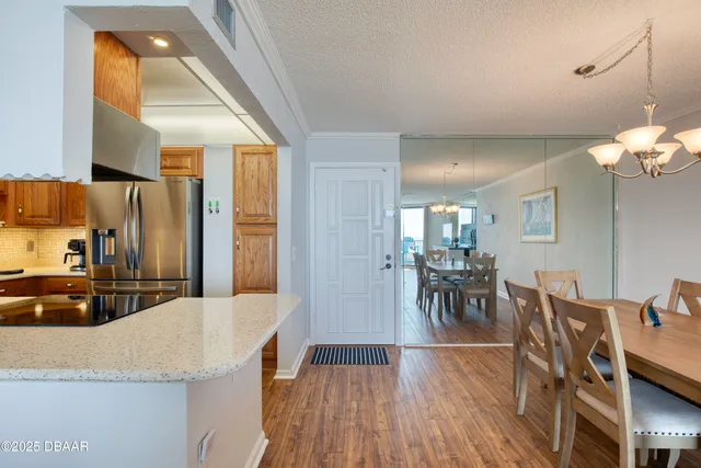 a large kitchen with stainless steel appliances granite countertop a large counter top and a wooden floors