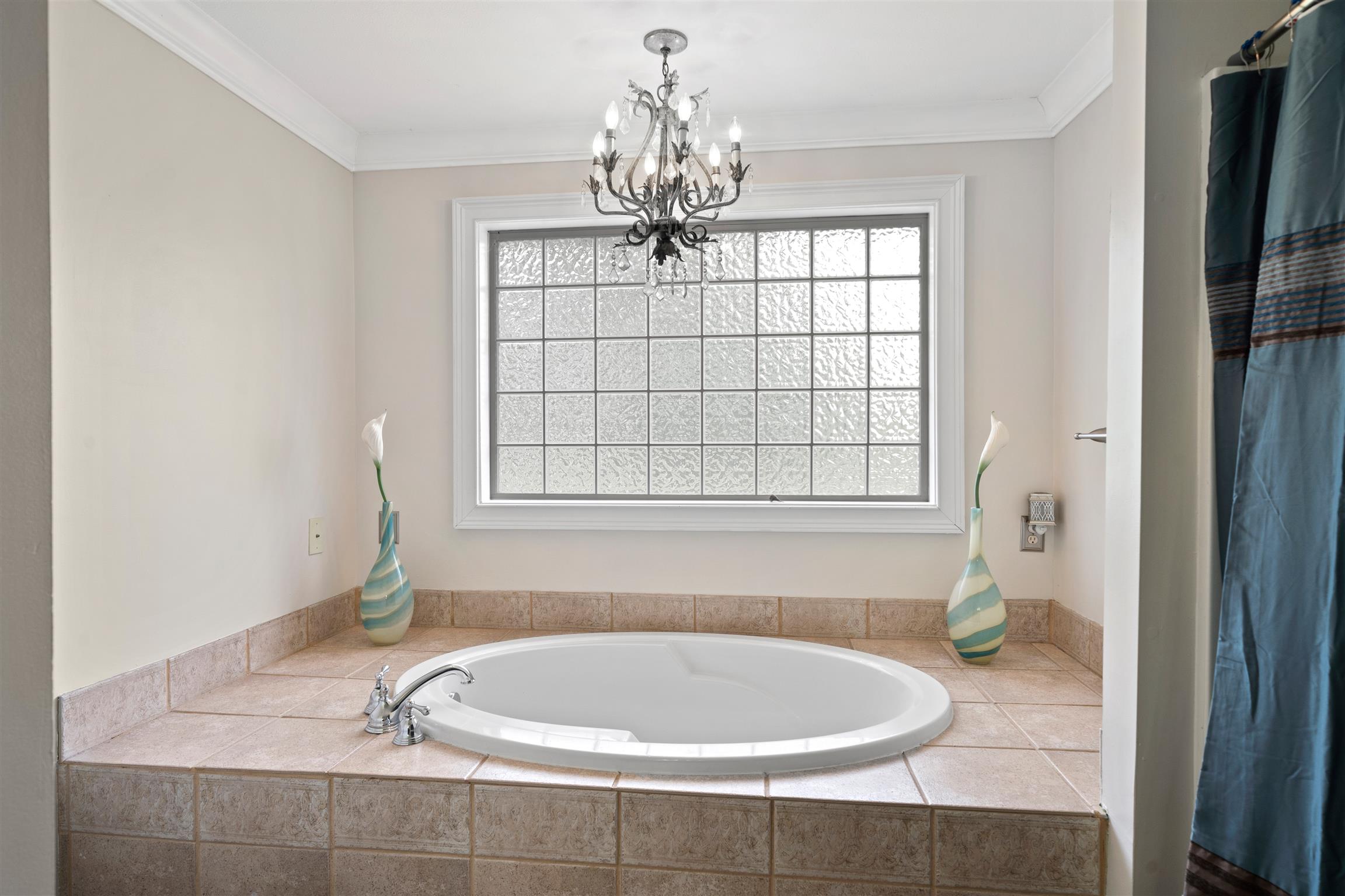6977 Woodruff Tolleson Road Adams, TN 37010 - Photo 11 of 27 a bathroom with a bathtub a window and a shower