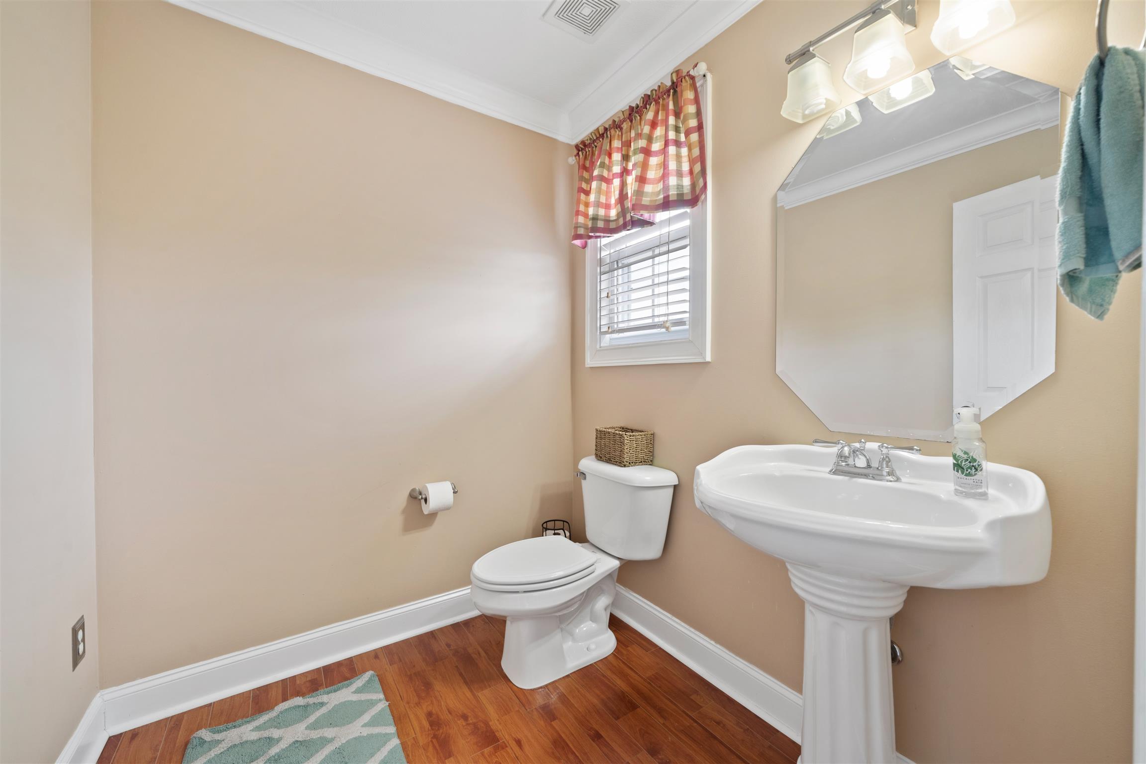 6977 Woodruff Tolleson Road Adams, TN 37010 - Photo 15 of 27 a bathroom with a sink toilet and a mirror