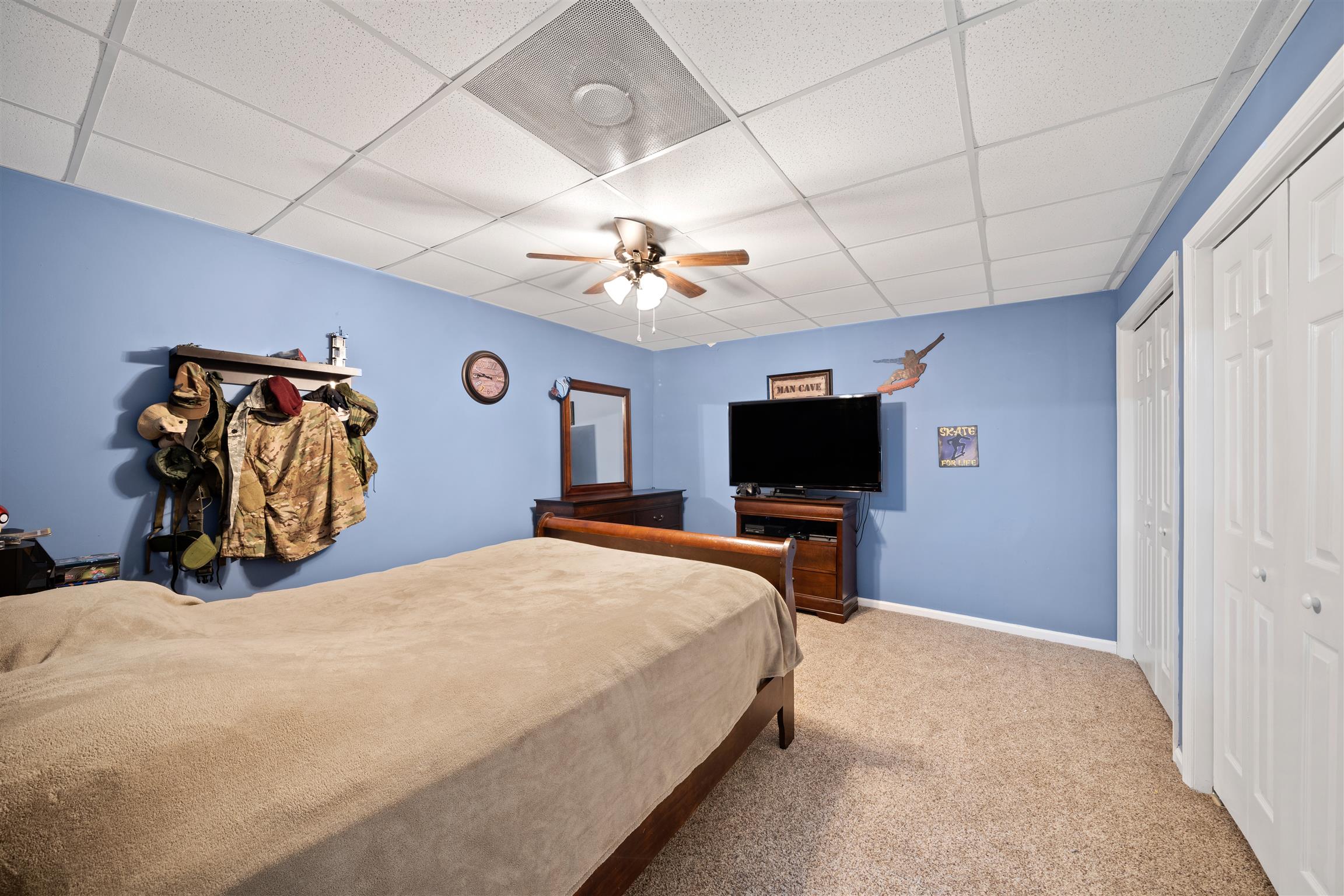 6977 Woodruff Tolleson Road Adams, TN 37010 - Photo 18 of 27 a bedroom with a bed and a flat screen tv