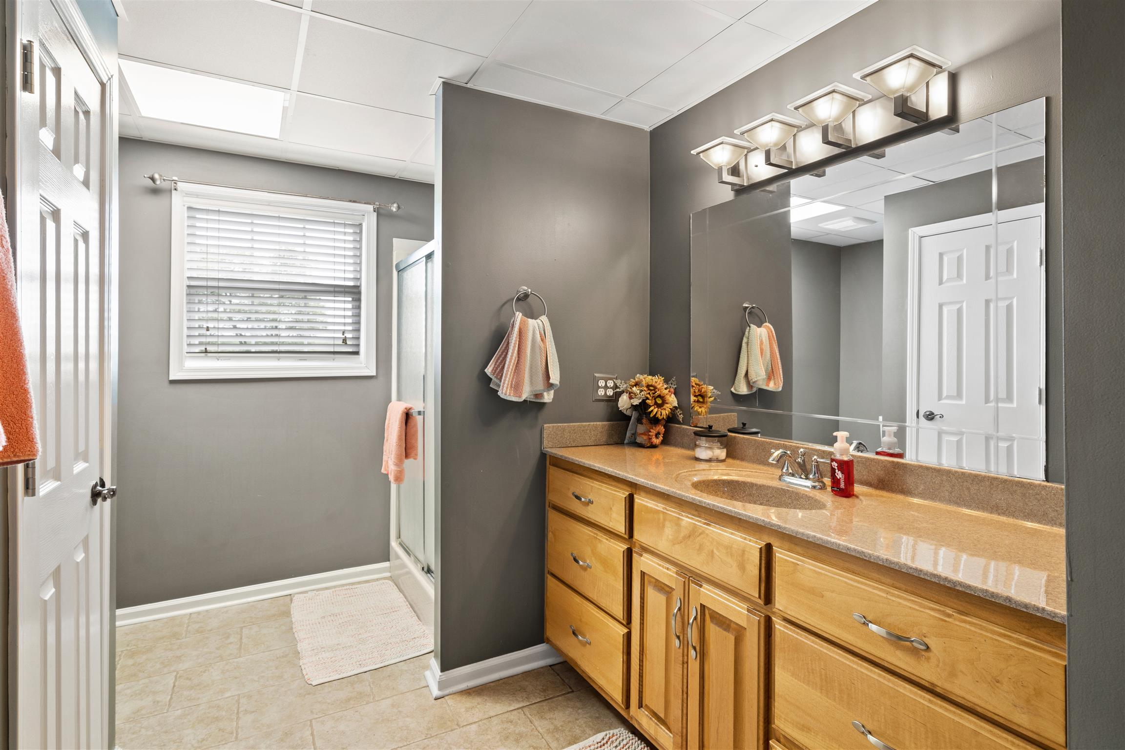 6977 Woodruff Tolleson Road Adams, TN 37010 - Photo 20 of 27 a bathroom with a double vanity sink and a mirror