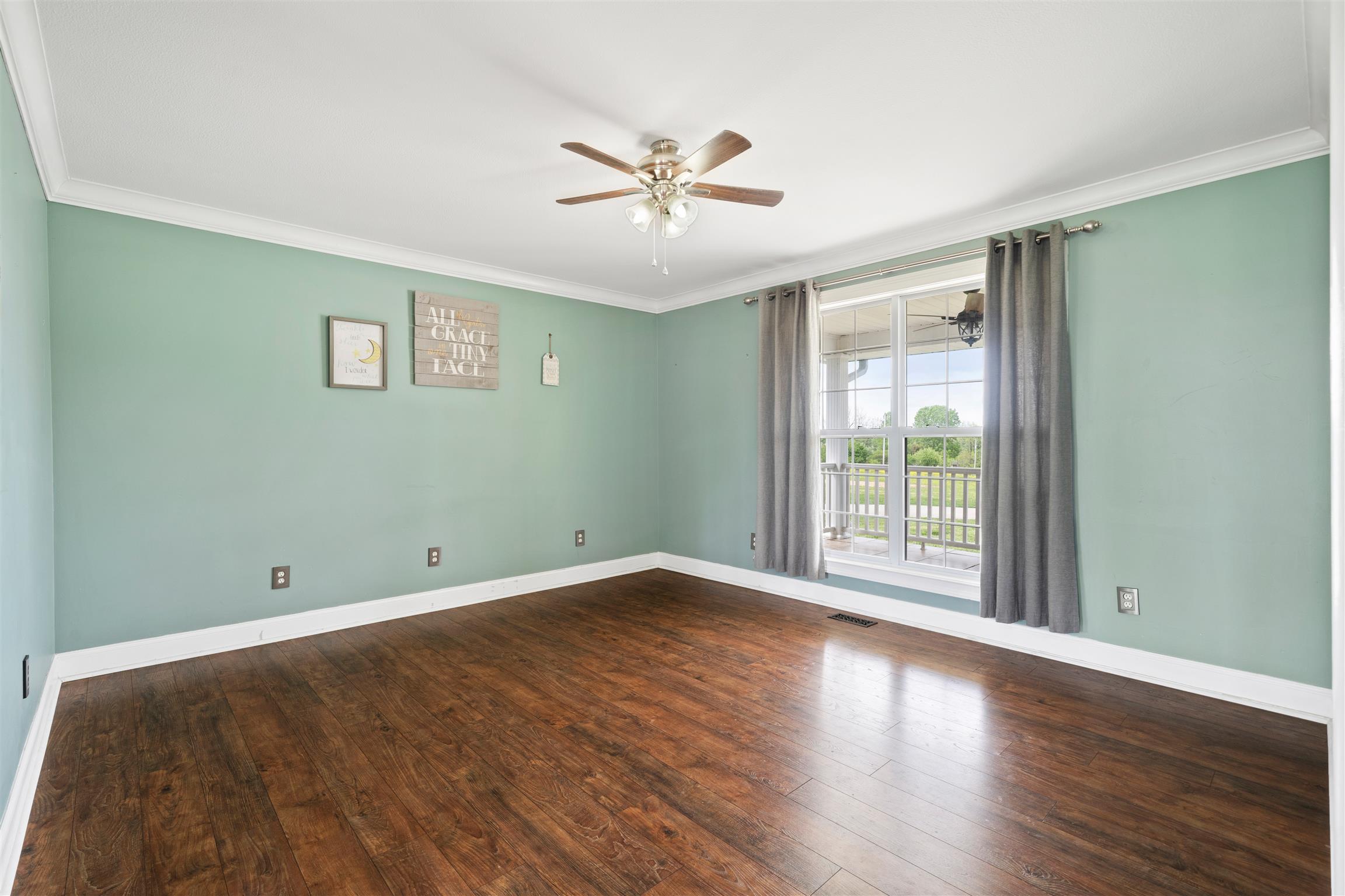 6977 Woodruff Tolleson Road Adams, TN 37010 - Photo 6 of 27 an empty room with wooden floor and windows