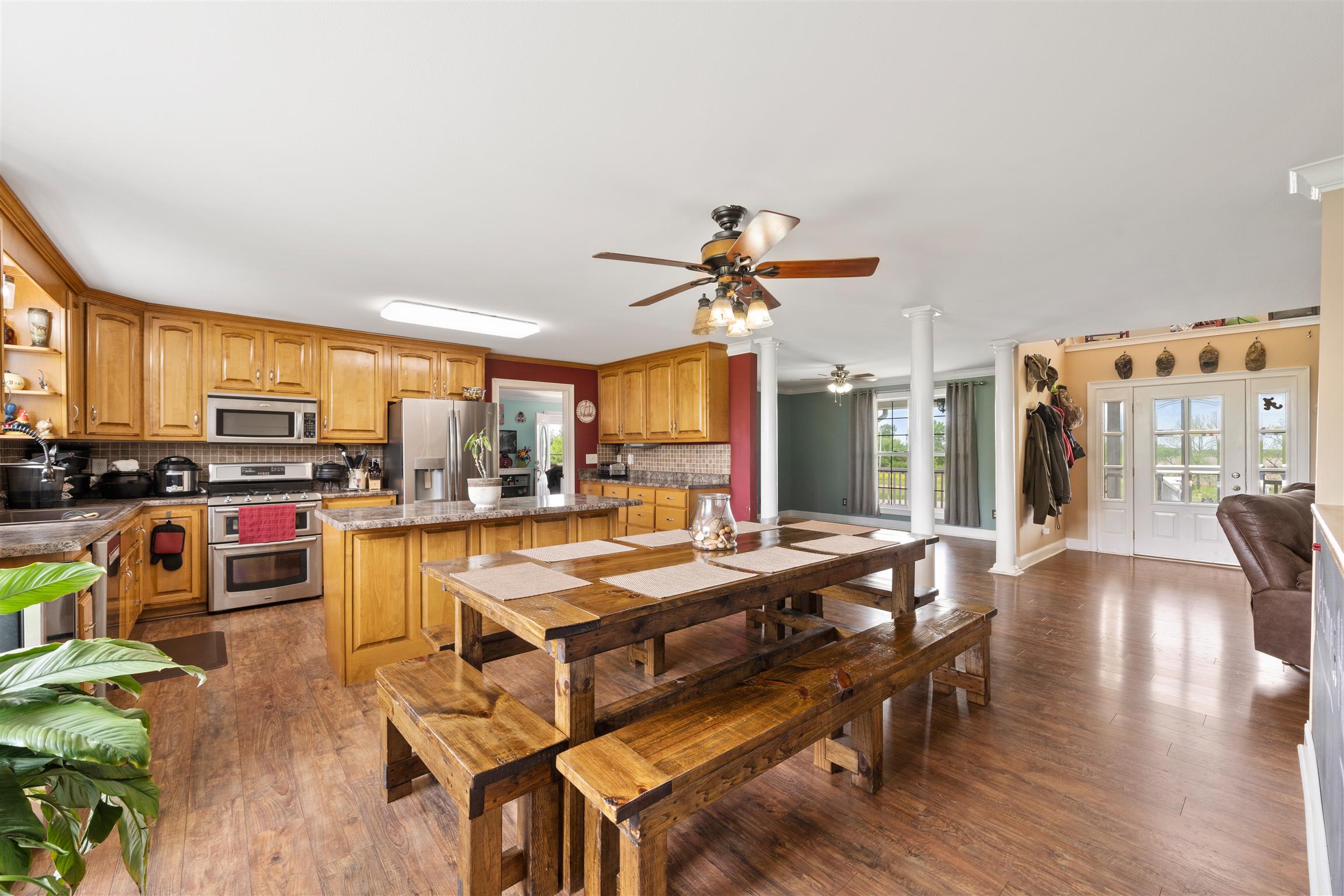 6977 Woodruff Tolleson Road Adams, TN 37010 - Photo 7 of 27 a dining hall with stainless steel appliances granite countertop a stove and a refrigerator