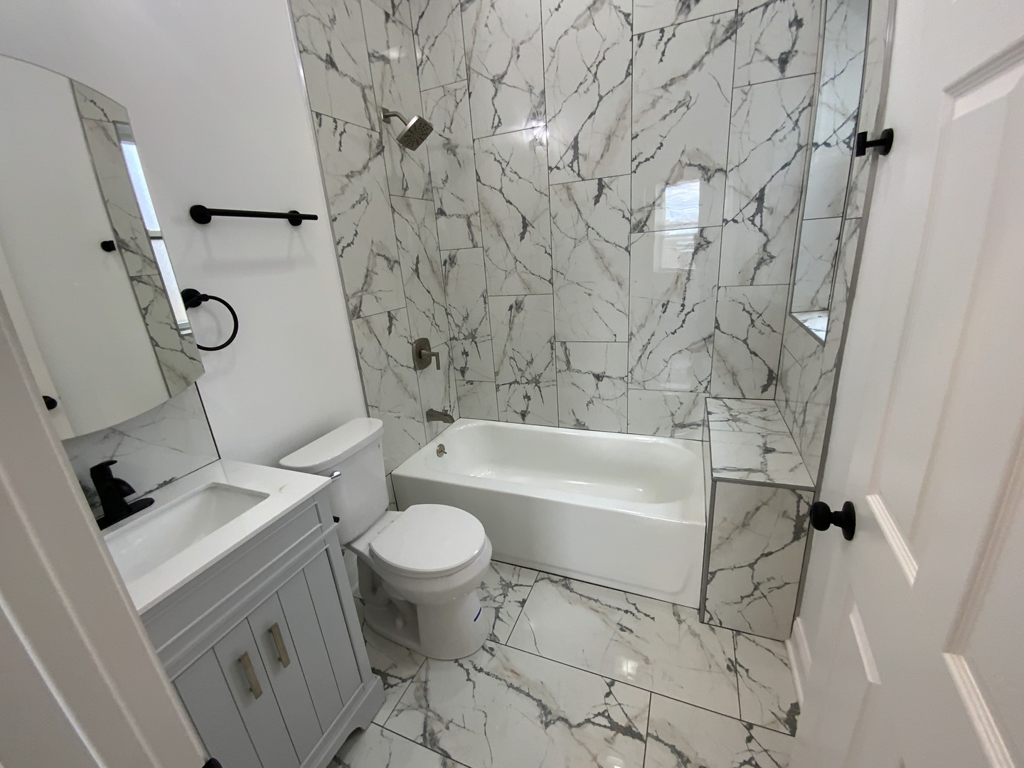 419 East 75th Street, Unit 3 Chicago, IL 60619 - Photo 6 of 11 a bathroom with a granite countertop sink toilet and shower