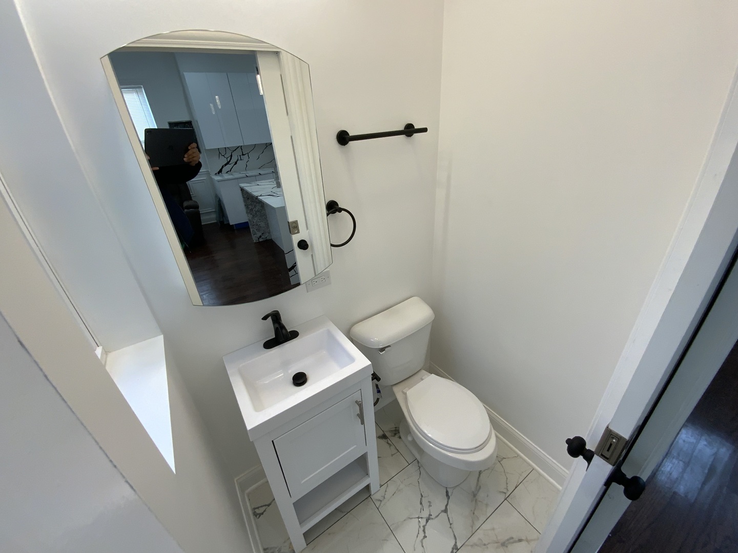 419 East 75th Street, Unit 3 Chicago, IL 60619 - Photo 7 of 11 a white toilet sitting next to a bathroom sink