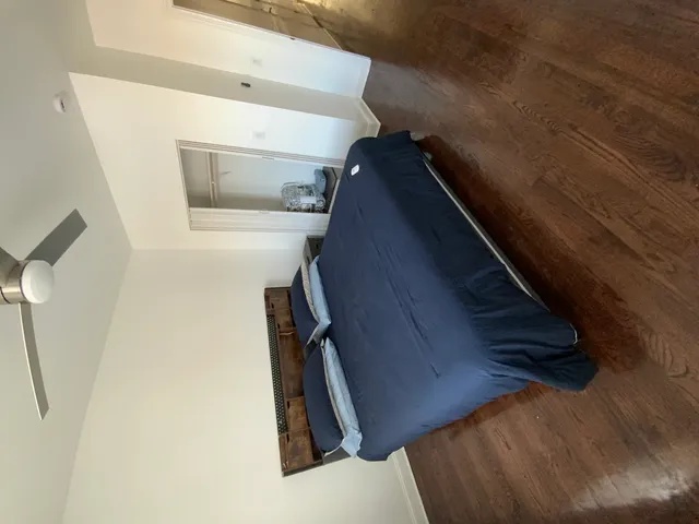 a bed sitting in a bedroom next to a window