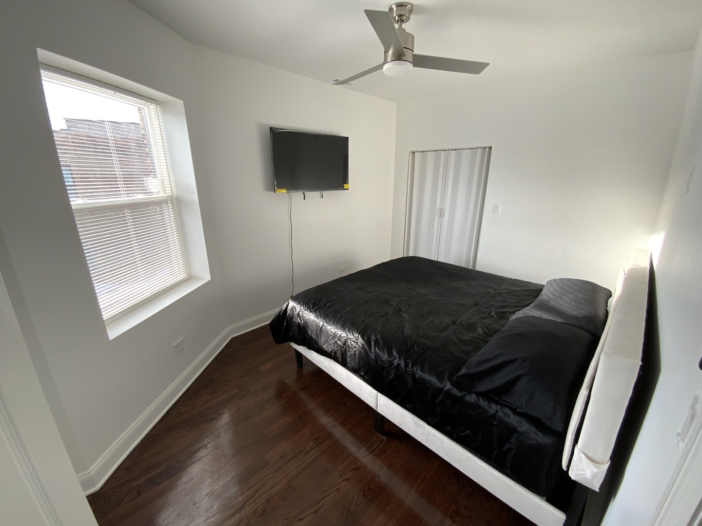 419 East 75th Street, Unit 3 Chicago, IL 60619 - Photo 9 of 11 a bed sitting in a bedroom next to a window