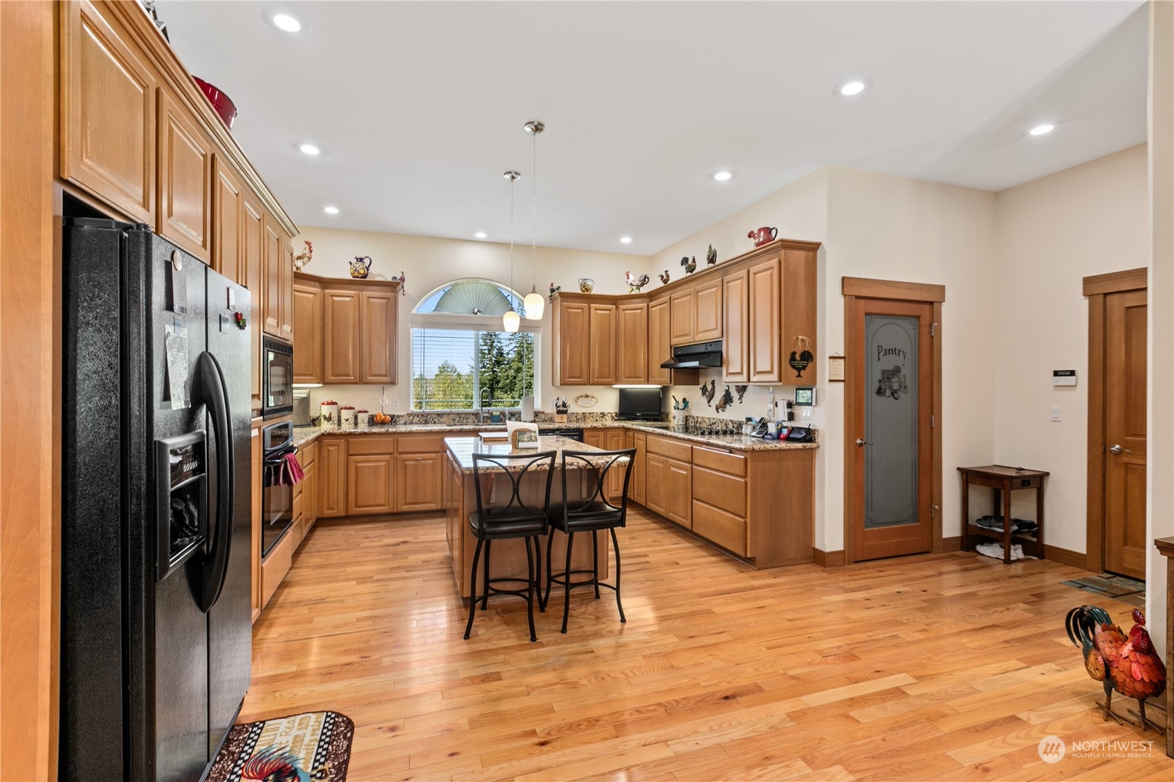 6605 Stringtown Road East Eatonville, WA 98328 - Photo 11 of 40 a kitchen with stainless steel appliances kitchen island granite countertop a refrigerator and a stove top oven