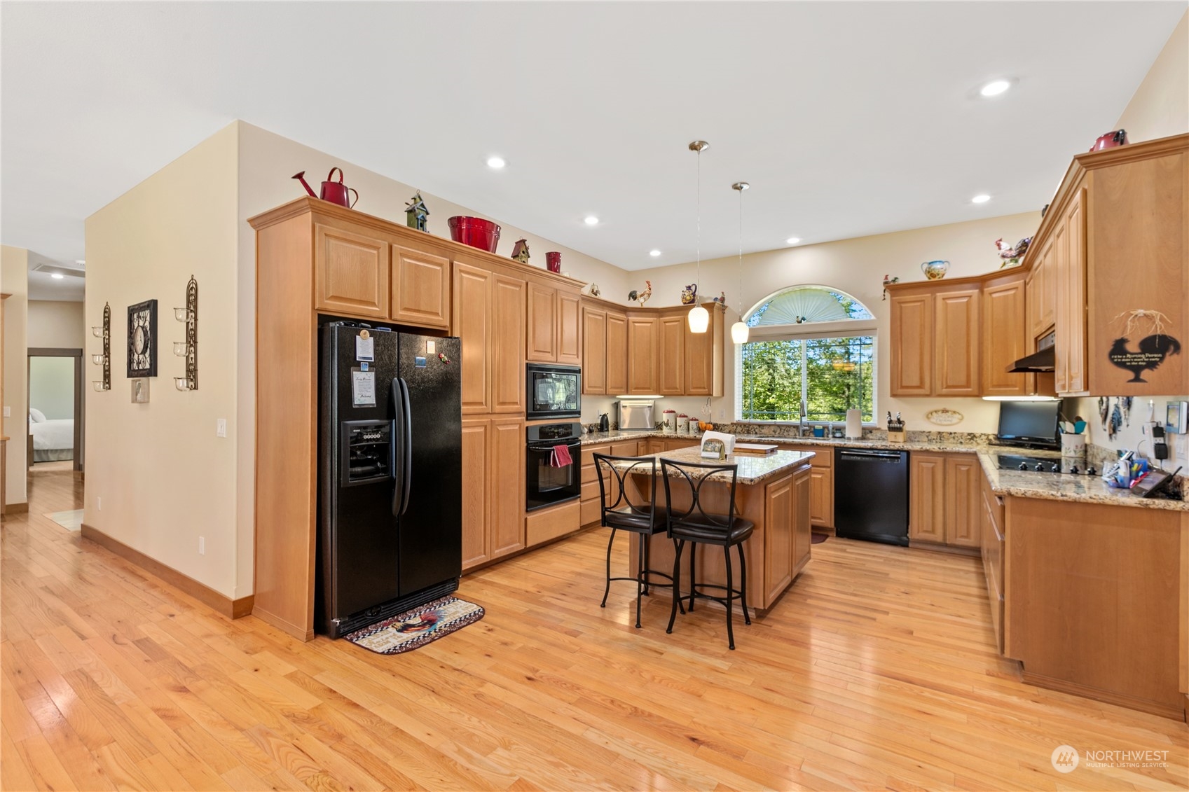 6605 Stringtown Road East Eatonville, WA 98328 - Photo 12 of 40 a kitchen with stainless steel appliances kitchen island granite countertop a refrigerator and a stove top oven