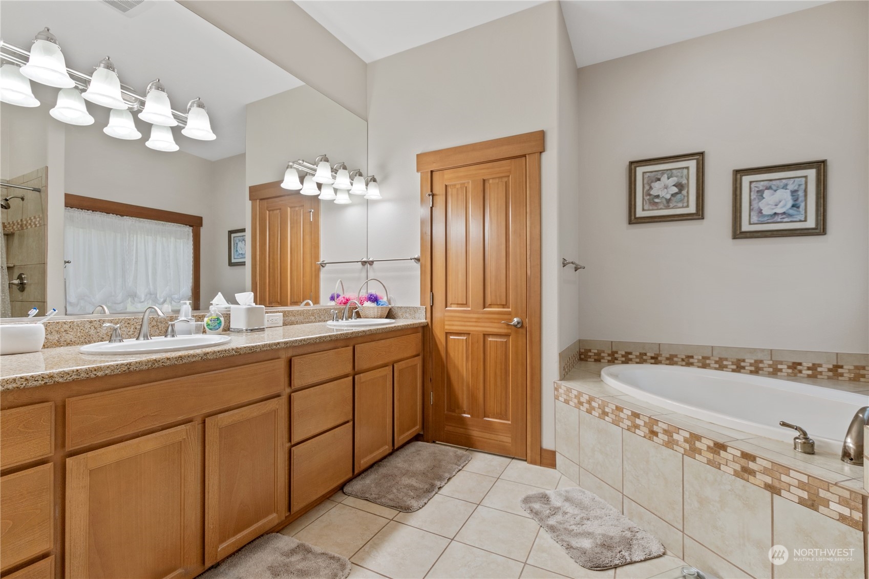 6605 Stringtown Road East Eatonville, WA 98328 - Photo 16 of 40 a spacious bathroom with a bathtub a sink and a mirror