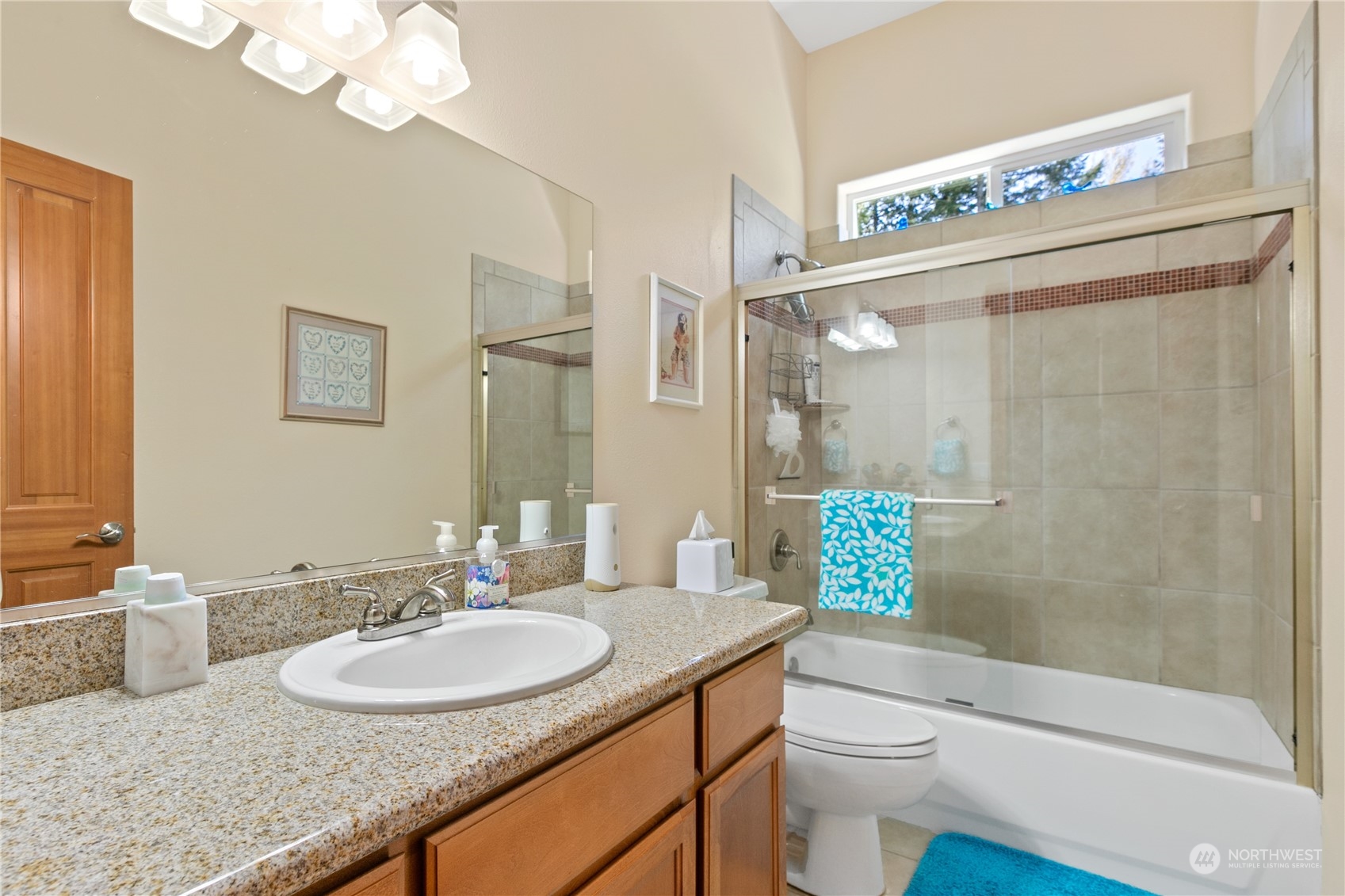 6605 Stringtown Road East Eatonville, WA 98328 - Photo 20 of 40 a bathroom with a granite countertop sink a toilet a mirror and shower