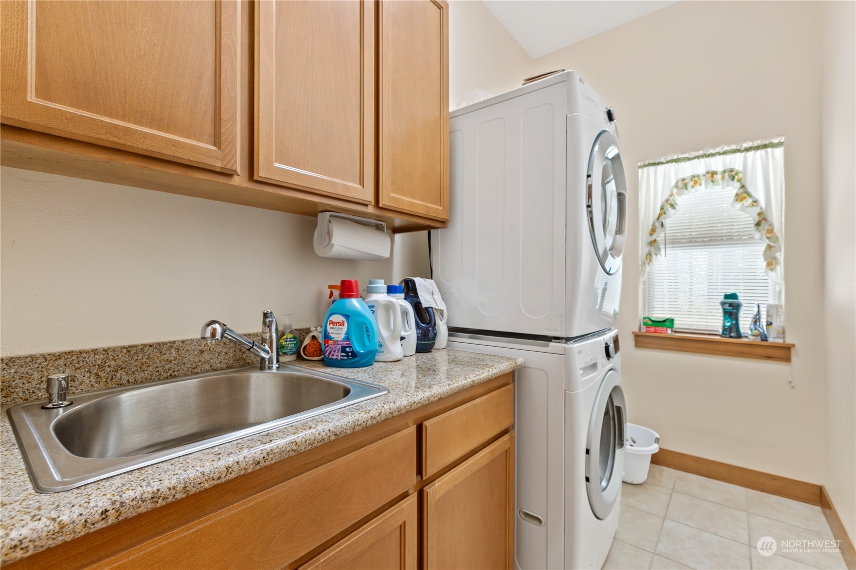 6605 Stringtown Road East Eatonville, WA 98328 - Photo 21 of 40 a kitchen with refrigerator a sink and cabinets
