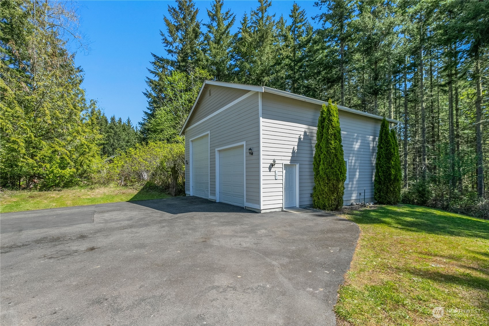 6605 Stringtown Road East Eatonville, WA 98328 - Photo 25 of 40 a view of a house with backyard and trees