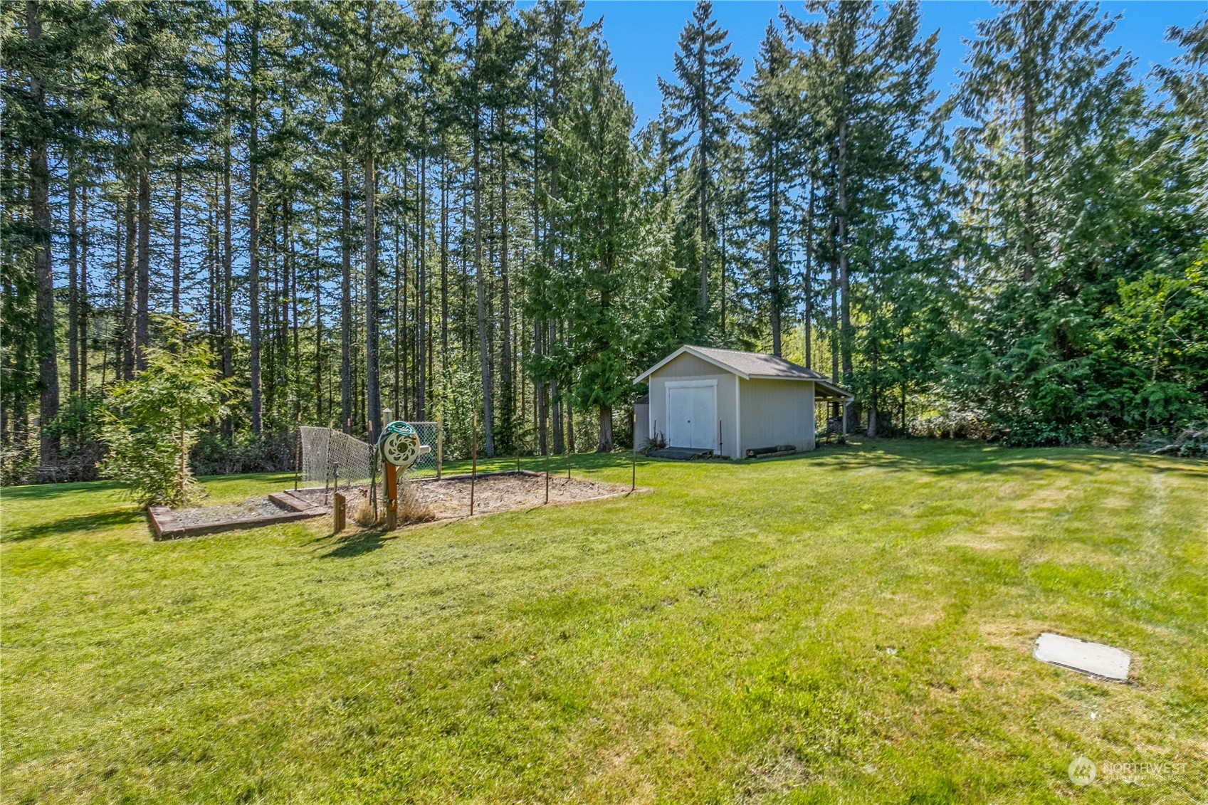 6605 Stringtown Road East Eatonville, WA 98328 - Photo 38 of 40 a swimming pool with lots of tress in front of it