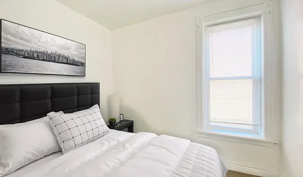 a bedroom with a bed and a window