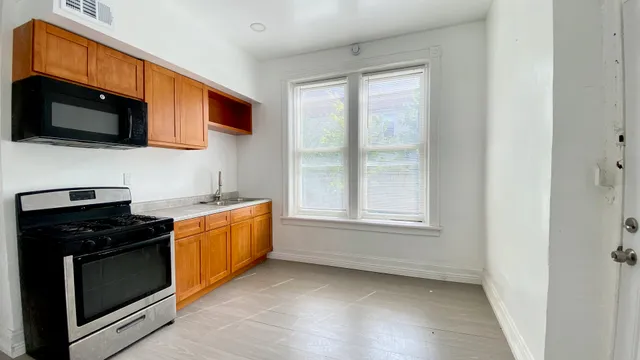 a kitchen with stainless steel appliances granite countertop a stove microwave and sink