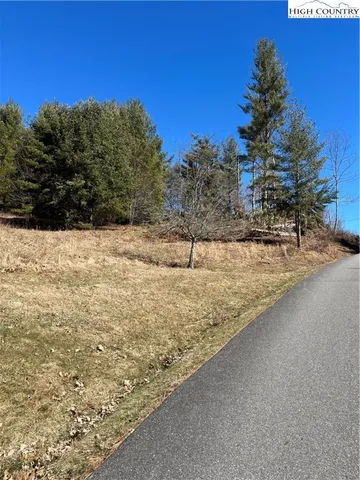a view of yard covered with snow in front of house