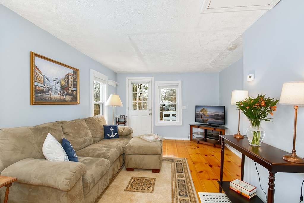 4 Acanthis Road Billerica, MA 01821 - Photo 3 of 12 a living room with furniture and a flat screen tv with wooden floor