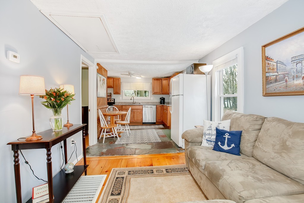 4 Acanthis Road Billerica, MA 01821 - Photo 4 of 12 a living room with furniture and a refrigerator