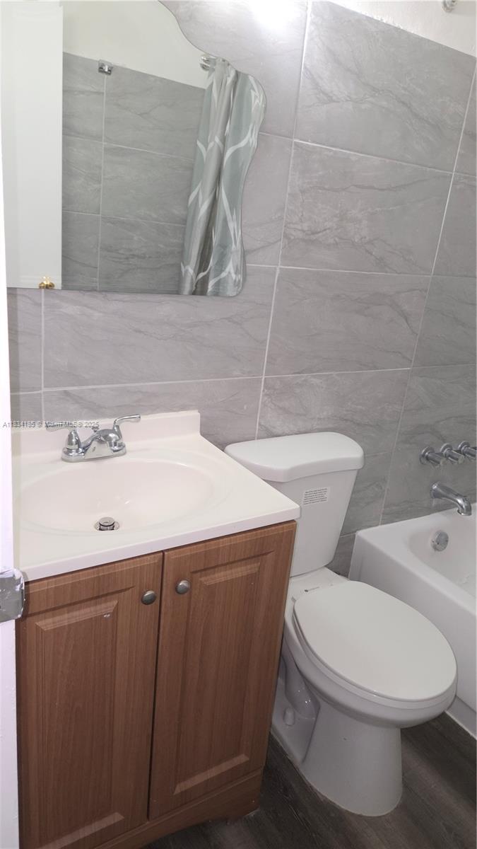 502-504 Phippen Waiters Road, Unit 3 Dania Beach, FL 33004 - Photo 15 of 17 a bathroom with a sink a toilet and shower