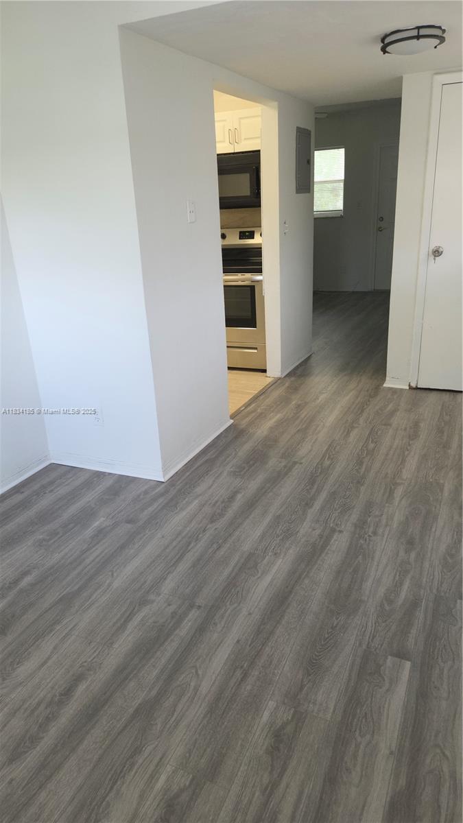 502-504 Phippen Waiters Road, Unit 3 Dania Beach, FL 33004 - Photo 4 of 17 an empty room with wooden floor & closet and windows