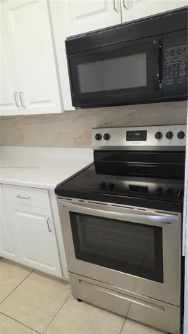 a stove top oven sitting inside of a kitchen
