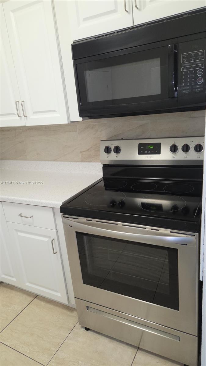 502-504 Phippen Waiters Road, Unit 3 Dania Beach, FL 33004 - Photo 6 of 17 a stove top oven sitting inside of a kitchen