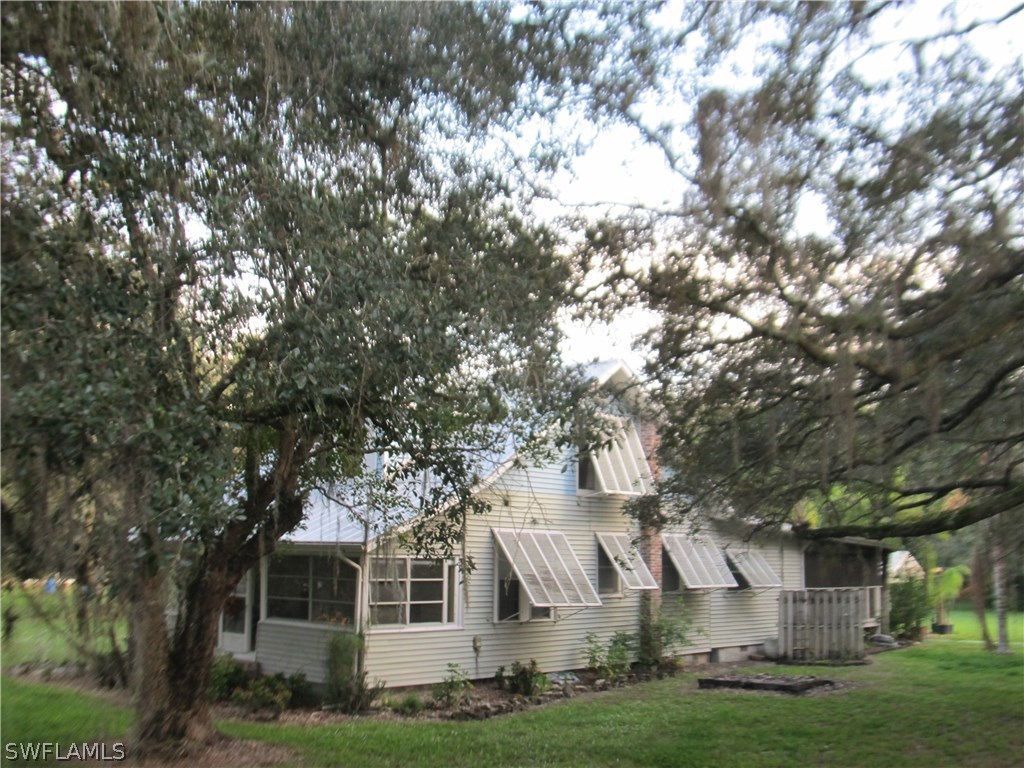 15850 Old Olga Road Alva, FL 33920 - Photo 2 of 11 a front view of a house with a yard