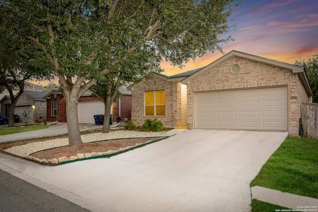 a front view of a house with yard garage and outdoor seating