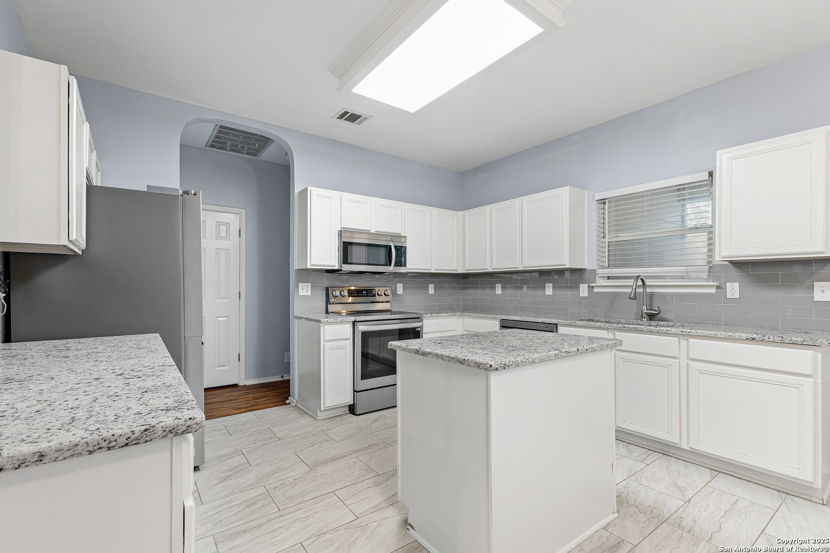 8522 Sonora Pass Helotes, TX 78023 - Photo 12 of 27 a kitchen with stainless steel appliances granite countertop a sink stove and refrigerator