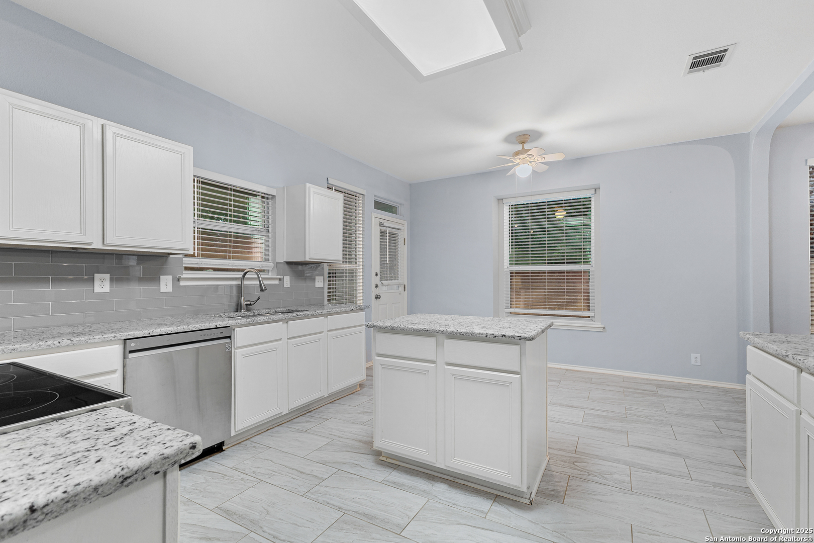 8522 Sonora Pass Helotes, TX 78023 - Photo 14 of 27 a kitchen with a stove sink and cabinets