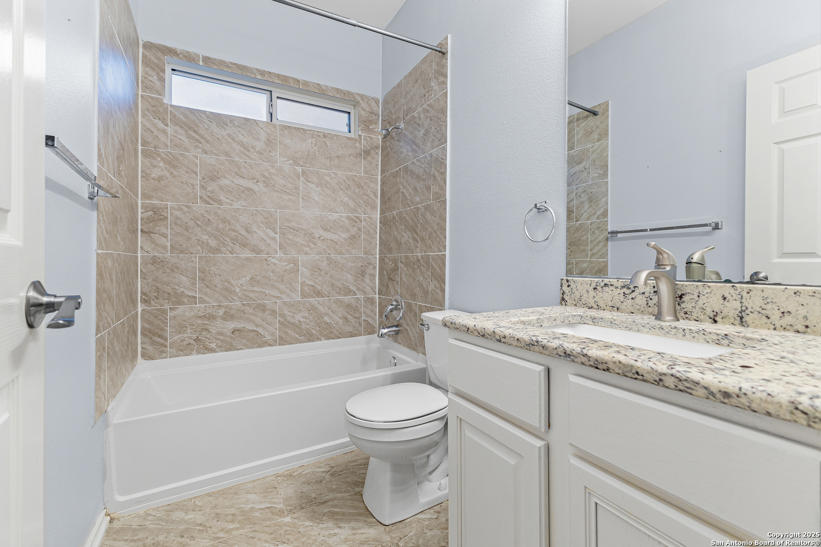 8522 Sonora Pass Helotes, TX 78023 - Photo 16 of 27 a bathroom with a granite countertop sink a toilet and bathtub