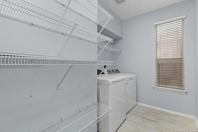 a utility room with cabinets washer and dryer