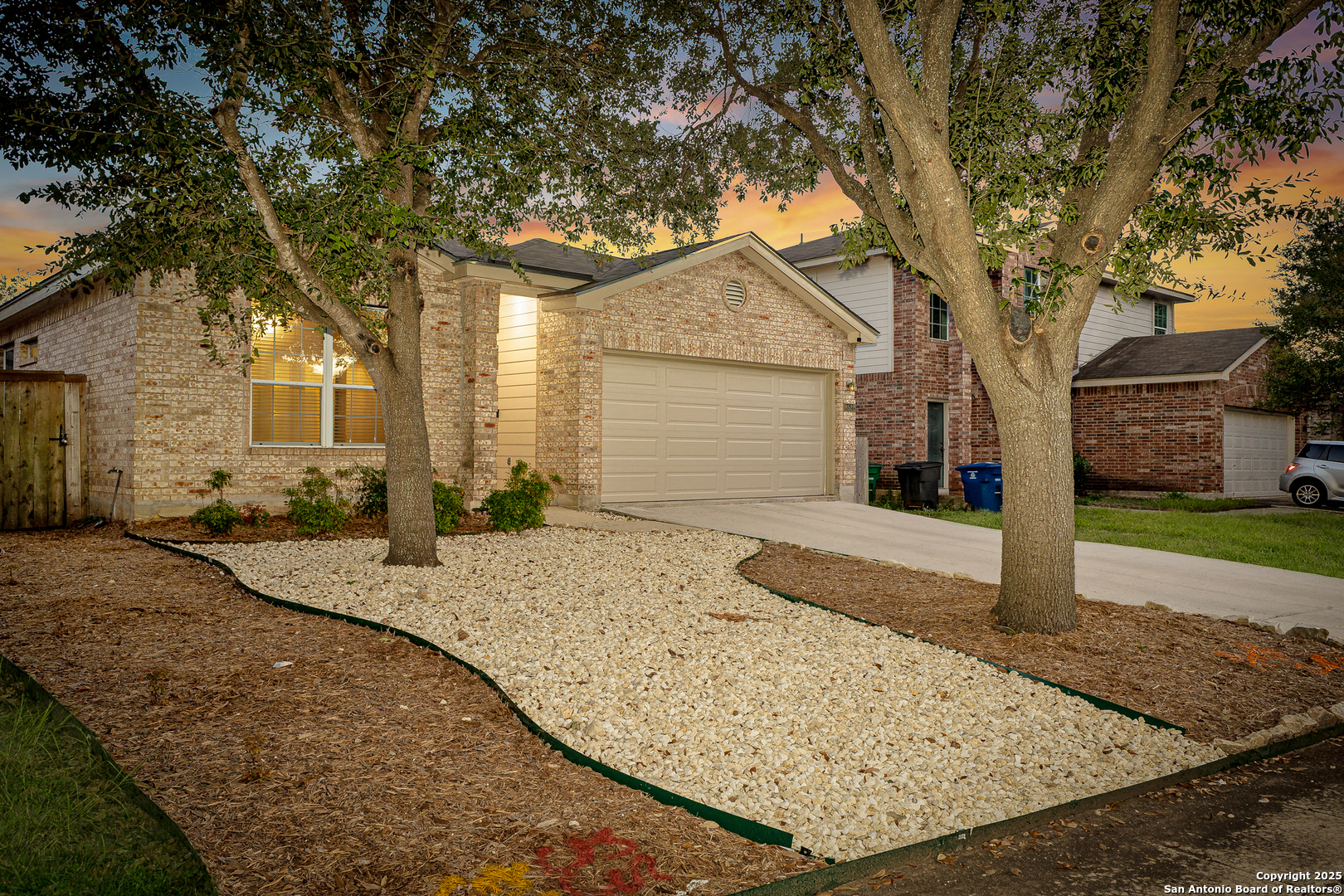 8522 Sonora Pass Helotes, TX 78023 - Photo 2 of 27 a front view of a house with a yard and garage