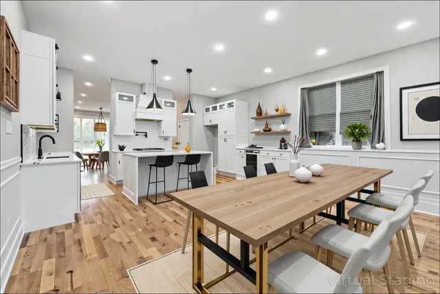 a large white kitchen with kitchen island a sink a stove and a refrigerator