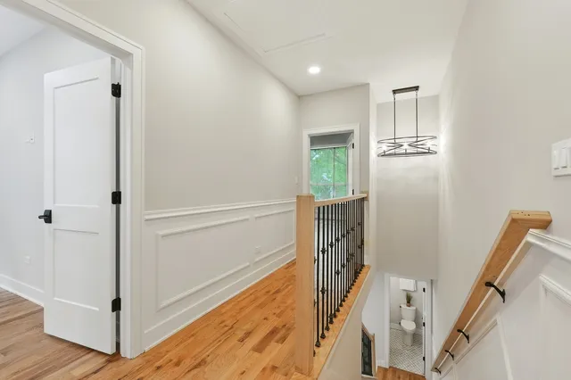 a bedroom with a large bed and a potted plant