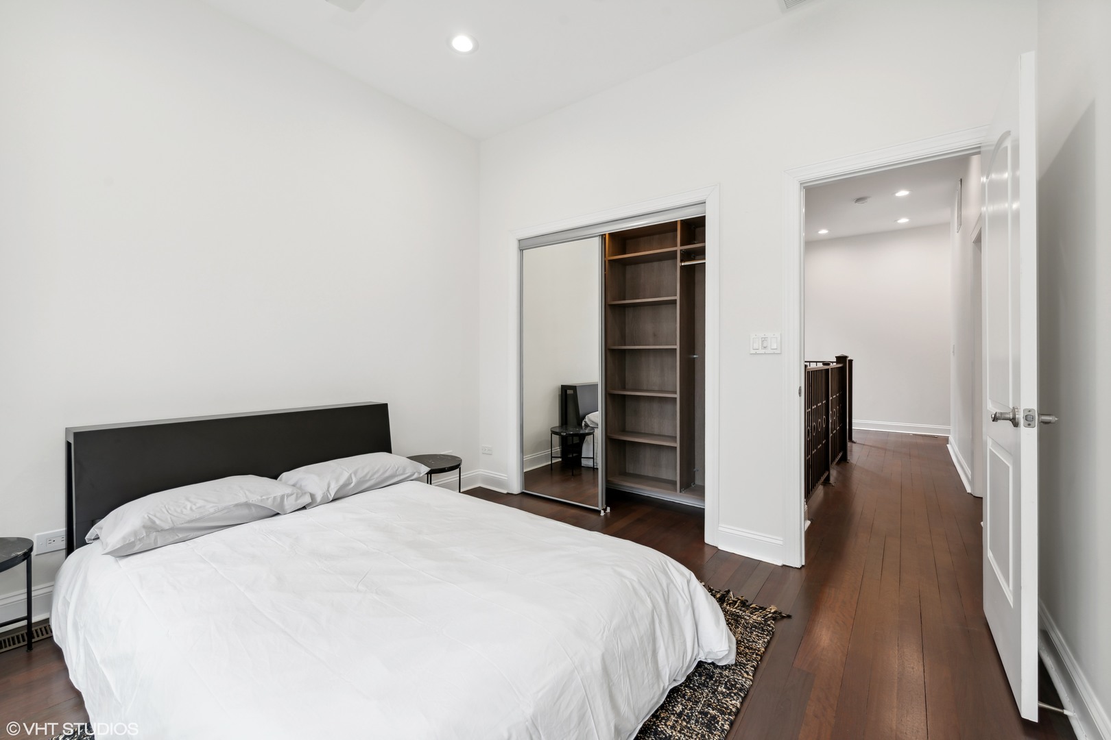 215 North Green Street, Unit 2 Chicago, IL 60607 - Photo 9 of 11 a bedroom with a bed and wooden floor