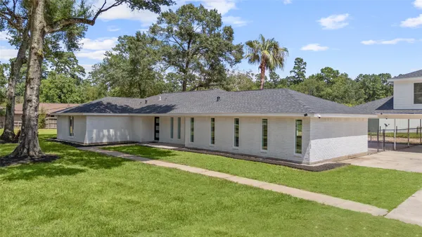 an aerial view of a house with garden space and street view