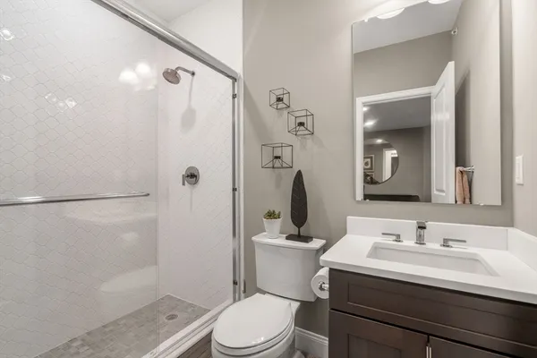 a bathroom with a sink toilet and shower