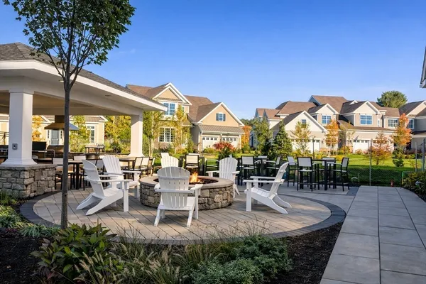 a view of a patio with dining table and chairs with a small yard