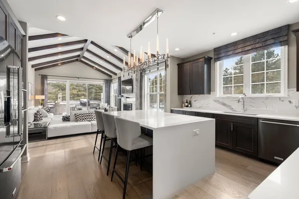 a kitchen with a table chairs sink and cabinets