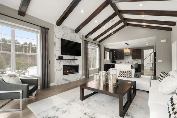 a living room with furniture a flat screen tv and a fireplace
