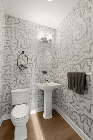 a bathroom with a toilet sink and mirror