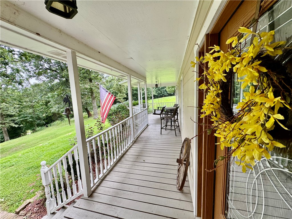 15196 Cincinnati Creek Road Summers, AR 72769 - Photo 9 of 42 Covered front porch with white railings, a paneled wood floor, and recessed lighting